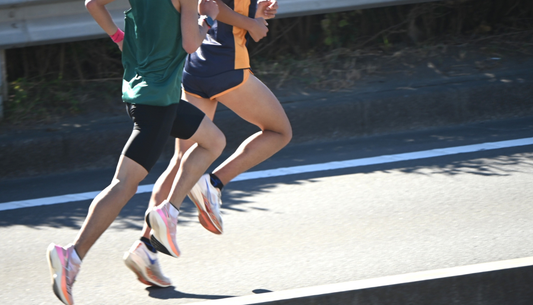 Why do elite trail runners prefer half tights over traditional split shorts?